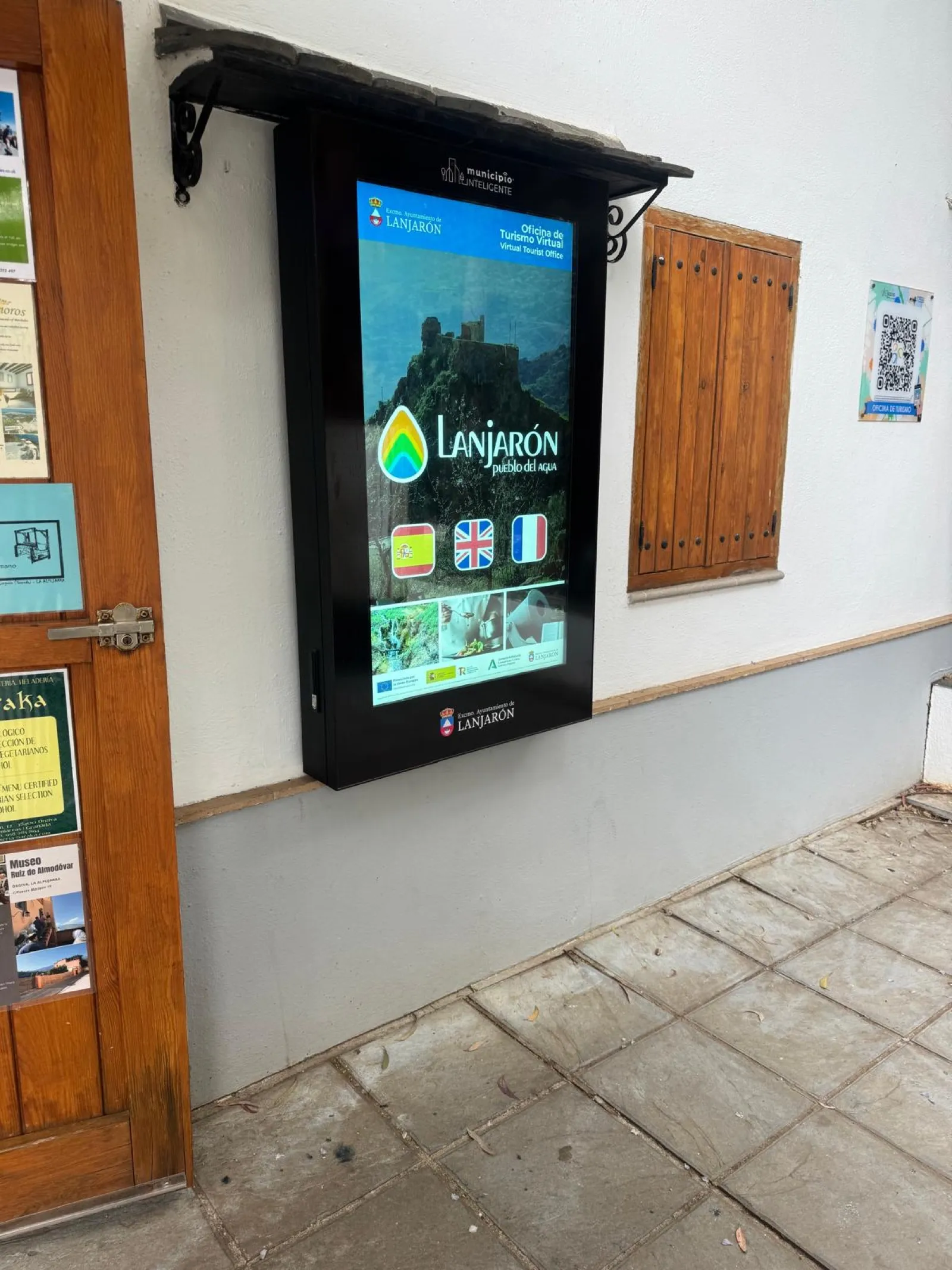 Visitante usando el mupi táctil con la oficina de turismo virtual